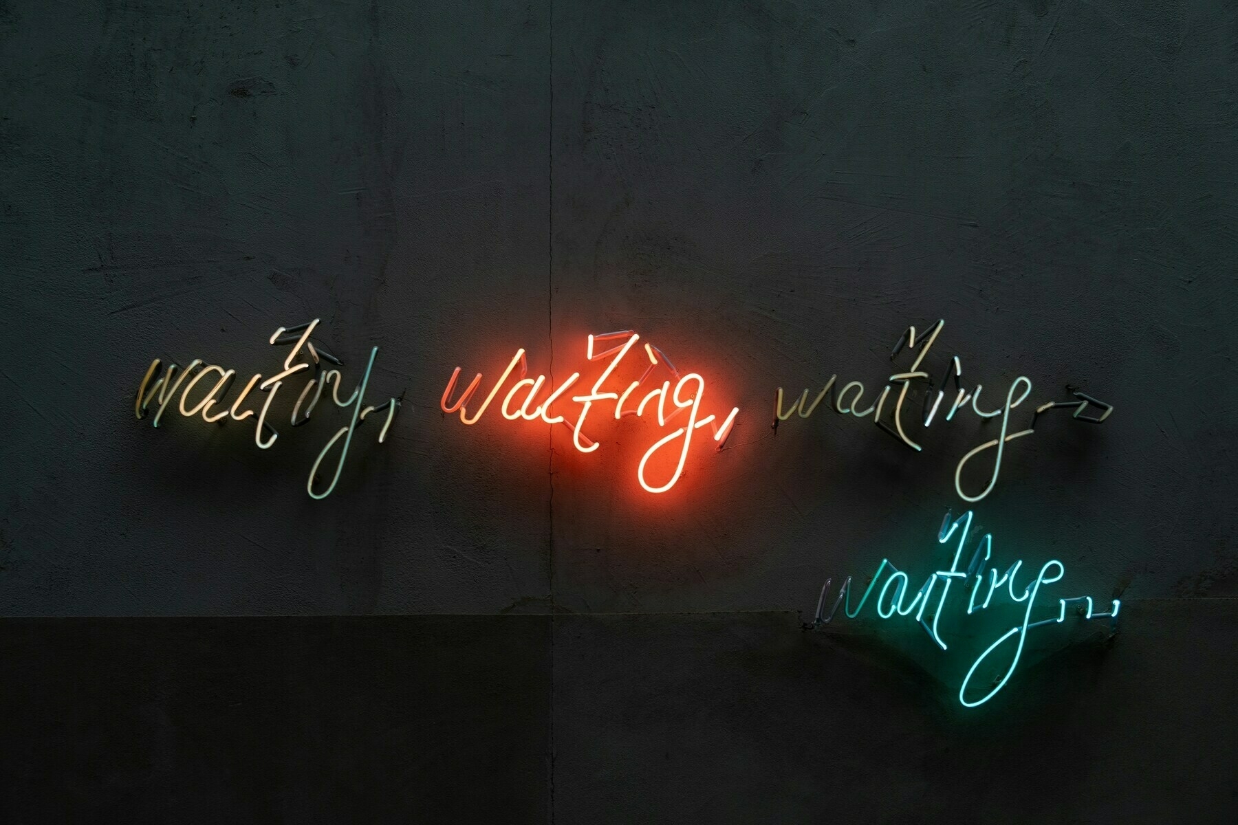 the word waiting in neon script